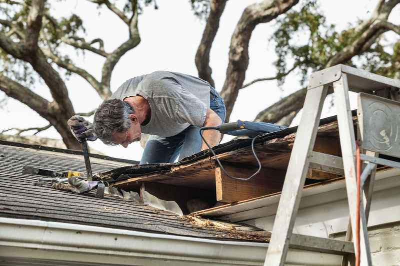 assessing storm damage on roof, Erie